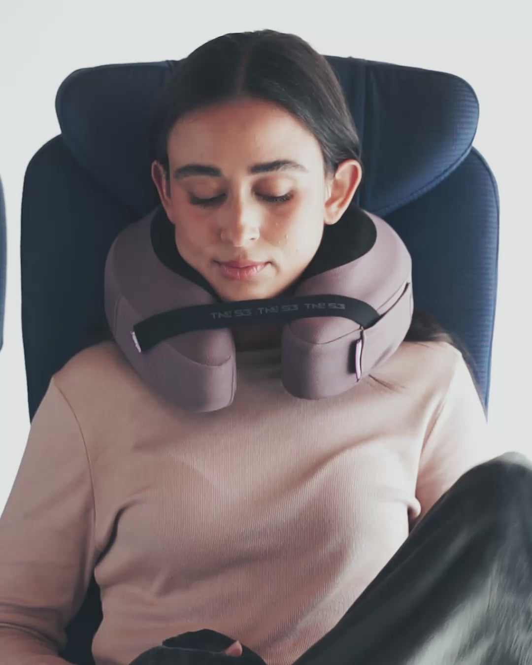 Traveler wearing blanket on flight